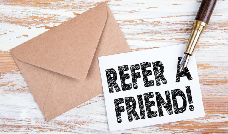 Refer a friend written on a piece of paper